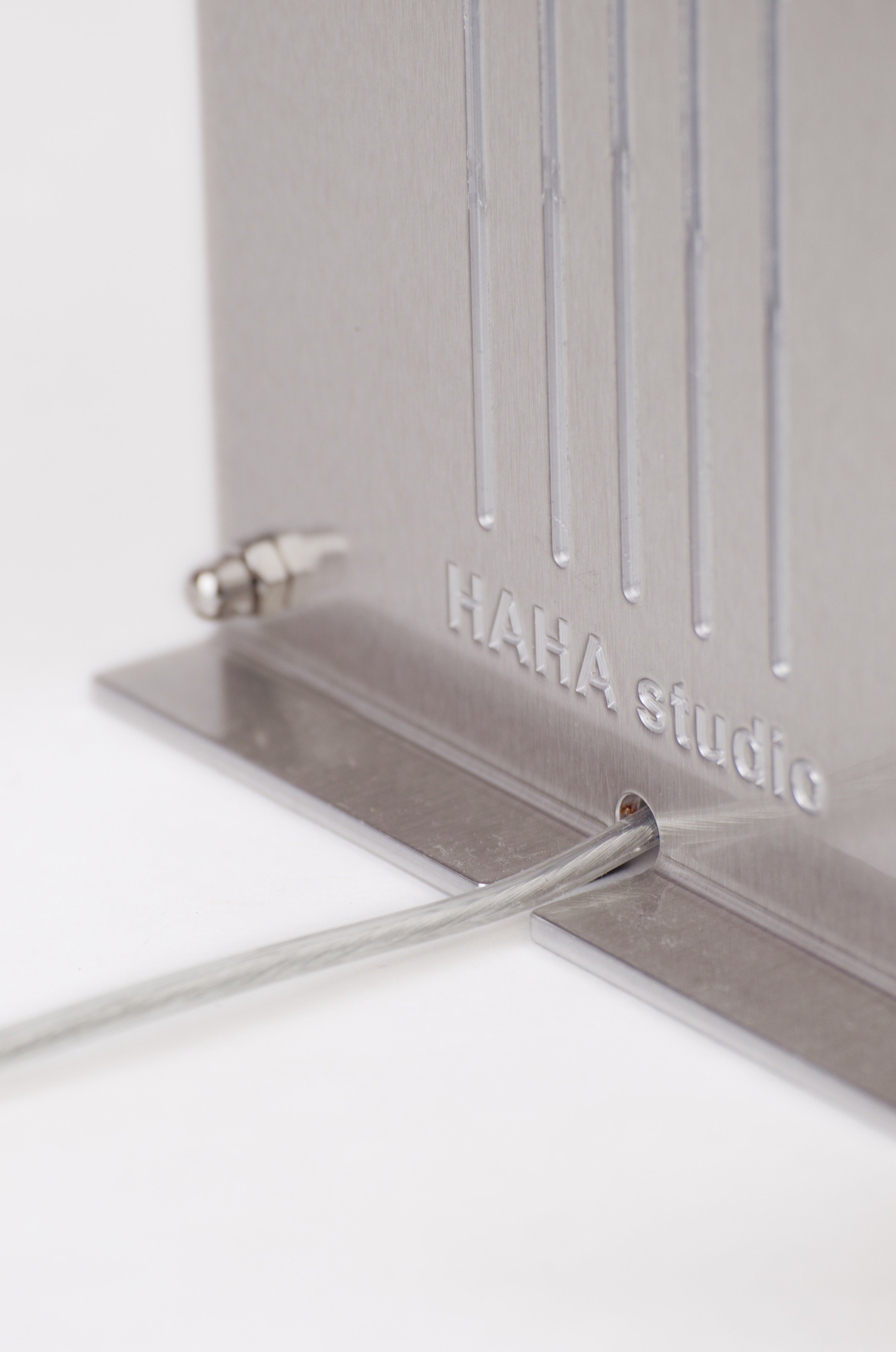 Grid table lamp by HAHA studio. Close-up view of the lamp’s back, showing the engraved logo ‘HAHA studio’.
