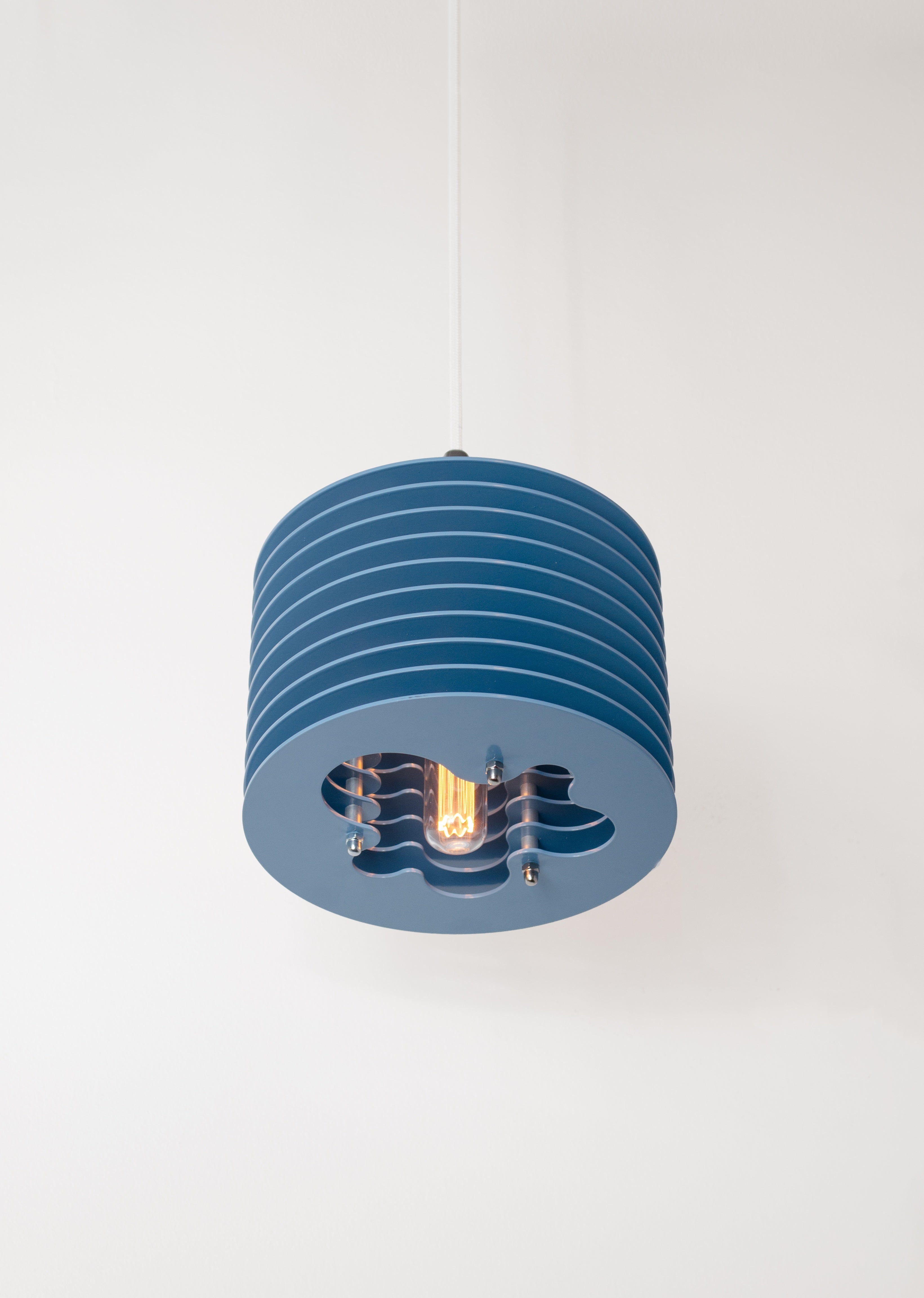 Splash pendant lamp by HAHA studio. Soft blue discs assembled with spacing, creating a soft, warm light.