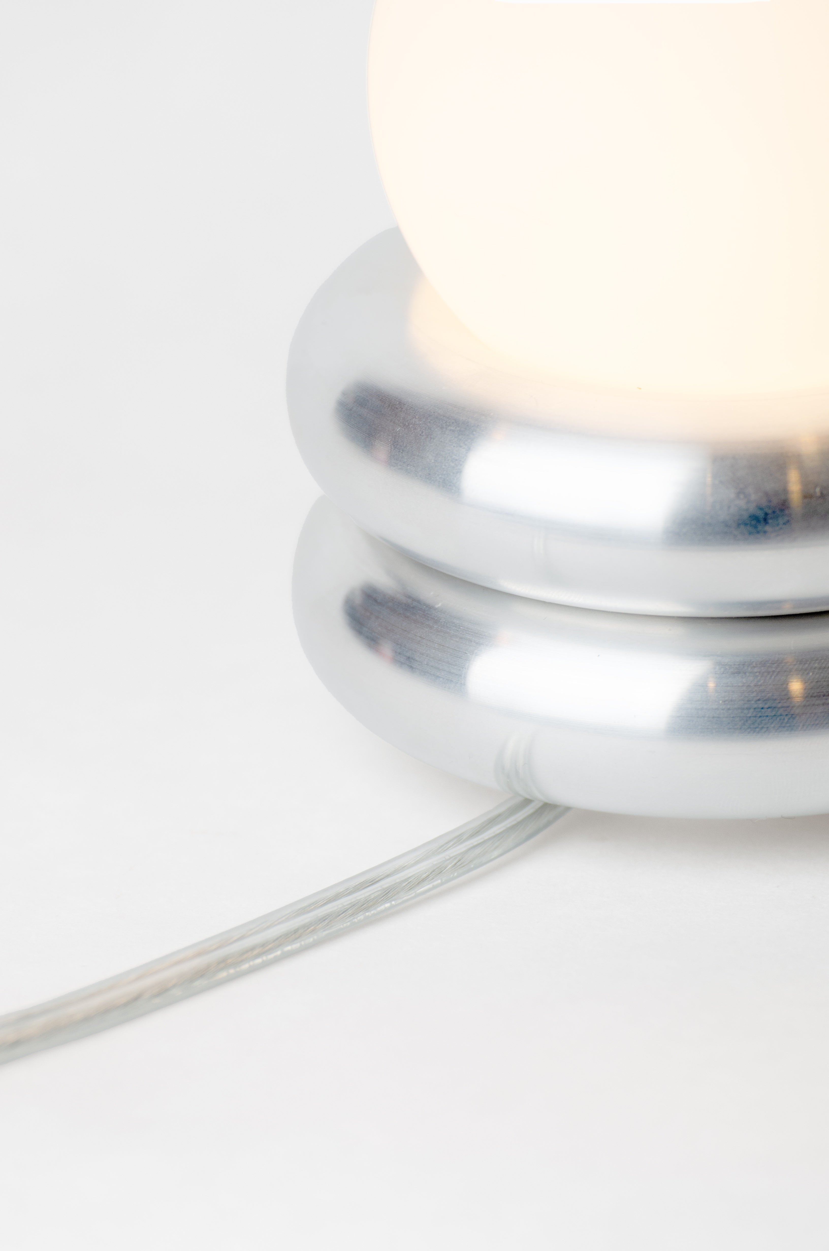 Donut lamp by HAHA studio. Close-up view showing the cord.